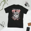 Flat lay of black "I Work Hard So My Cat Has a Better Life" t-shirt with props on white surface