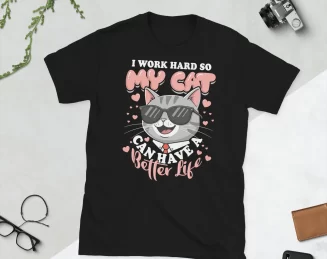Black I Work Hard for My Cat T-Shirt Flat Lay Flat lay of black "I Work Hard So My Cat Has a Better Life" t-shirt with props on white surface