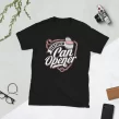 Flat lay of black Certified Can Opener cat parent shirt styled with scissors and greenery
