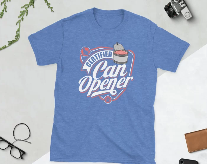 Heather Royal Certified Can Opener Shirt Flat Lay Flat lay of Heather Royal Certified Can Opener cat tee styled with plant and accessories