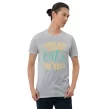 Man modeling light gray "Cat’s the Boss" t-shirt with casual pose and confident expression