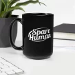Black Spare Human mug on white desk next to computer and green plant
