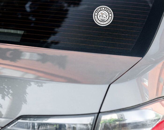 weatherproof-pet-lover-bumper-sticker-car-decal Minimalist Spare Human Society logo sticker on rear windshield of a silver car