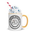 Yellow-handle mug with Spare Human Society logo and whipped cream topping, perfect for pet lovers