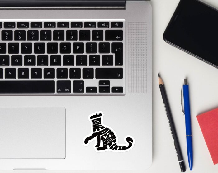 funny-rescue-cat-laptop-sticker-on-keyboard I Love Rescue Cats sticker next to laptop keyboard on silver MacBook for pet parents