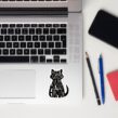 Proud Spare Human cat sticker displayed next to trackpad on a silver laptop
