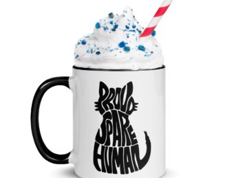 White ceramic mug with black handle featuring Proud Spare Human design and whipped topping