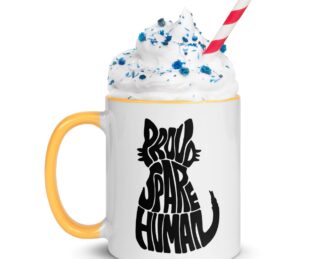 Proud Spare Human cat mug with yellow handle and rim, topped with whipped cream and sprinkles