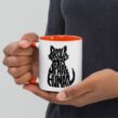 Person holding mug with red interior and Proud Spare Human graphic for cat dads