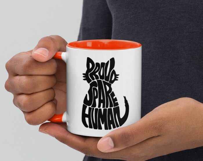 cat-dad-mug-funny-red-interior-coffee-cup Person holding mug with red interior and Proud Spare Human graphic for cat dads